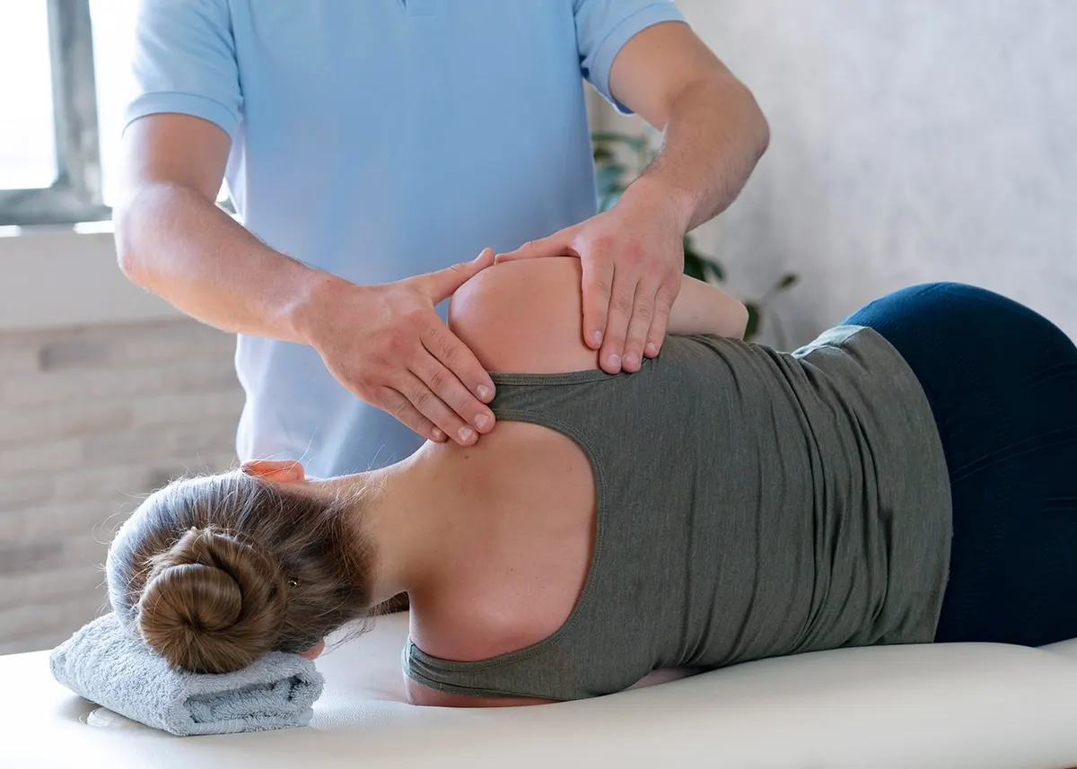 Therapist treating a patient’s shoulder