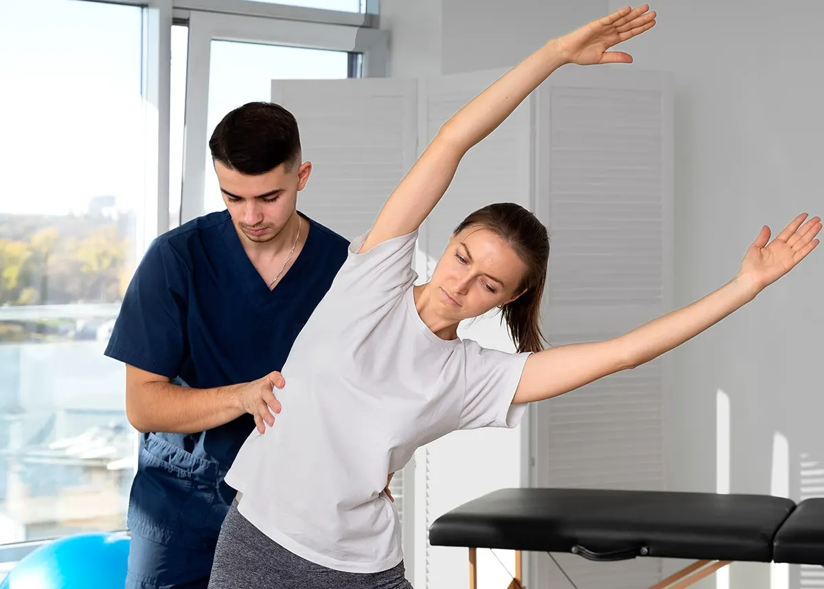 Therapist assessing a patient’s movement and flexibility